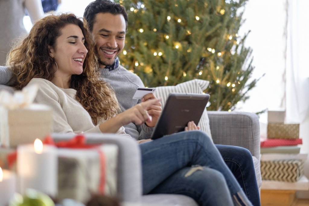 Couple reviewing online purchases for the holidays